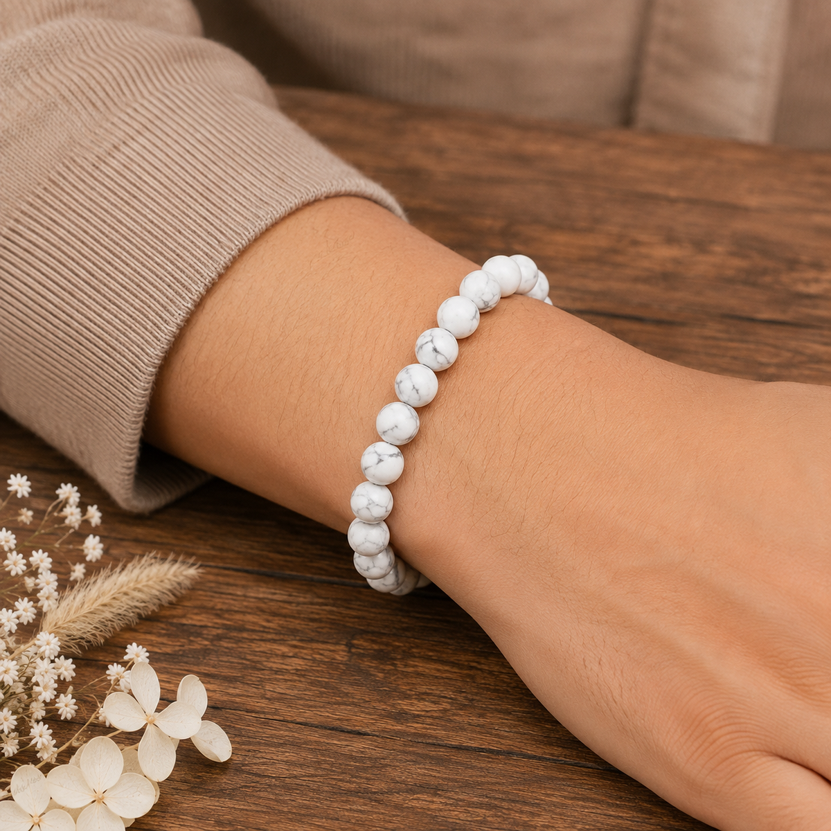 Certified natural Howlite bracelet with white grey-veined beads worn on wrist