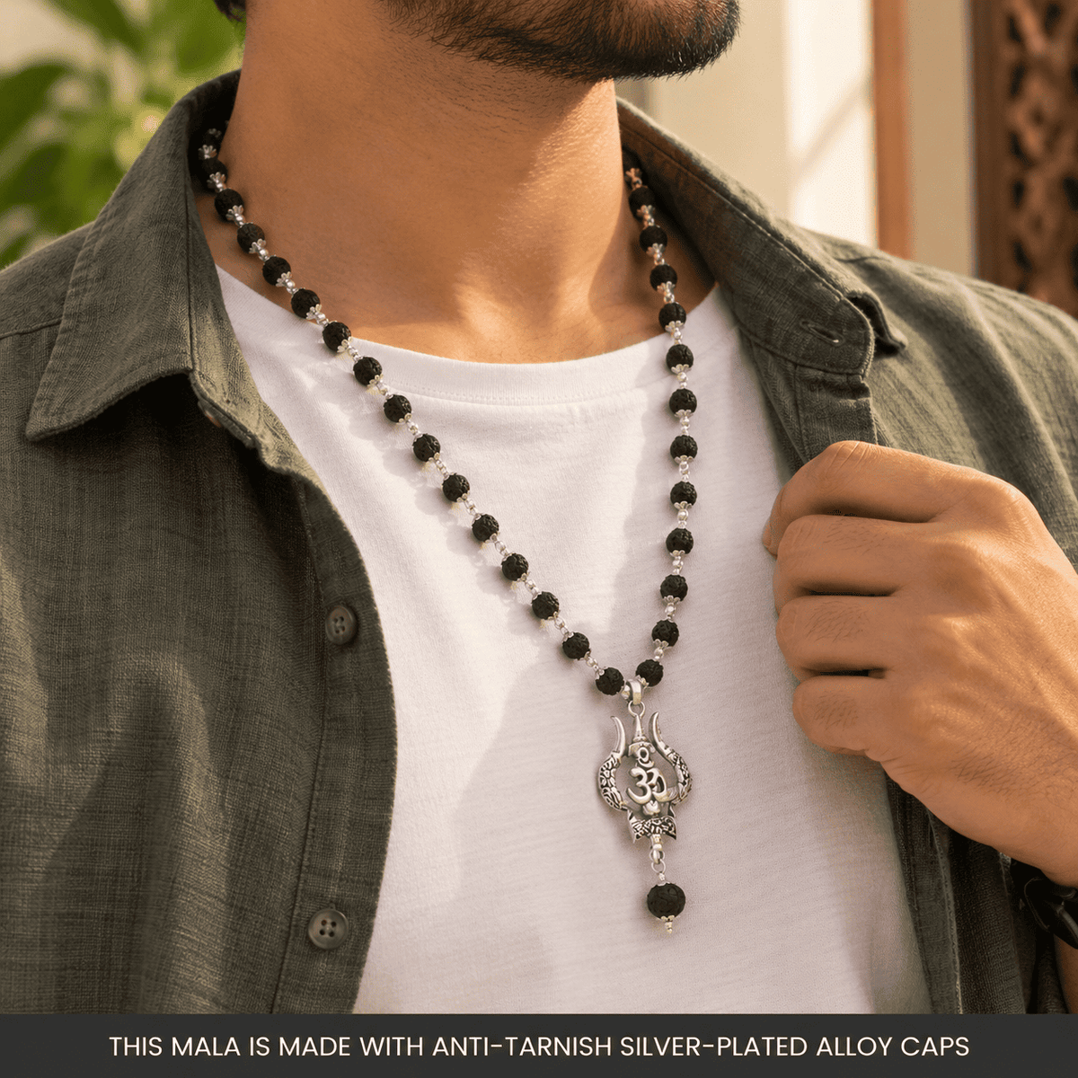 Man wearing a Karungali Mala with Om Shiva Trishul pendant over a traditional Indian outfit