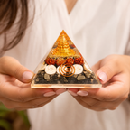 Lakshmi Yantra Orgonite Pyramid held by hand showing product details and natural elements