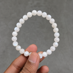 Close-up of AAA quality natural Moonstone bracelet held by hand