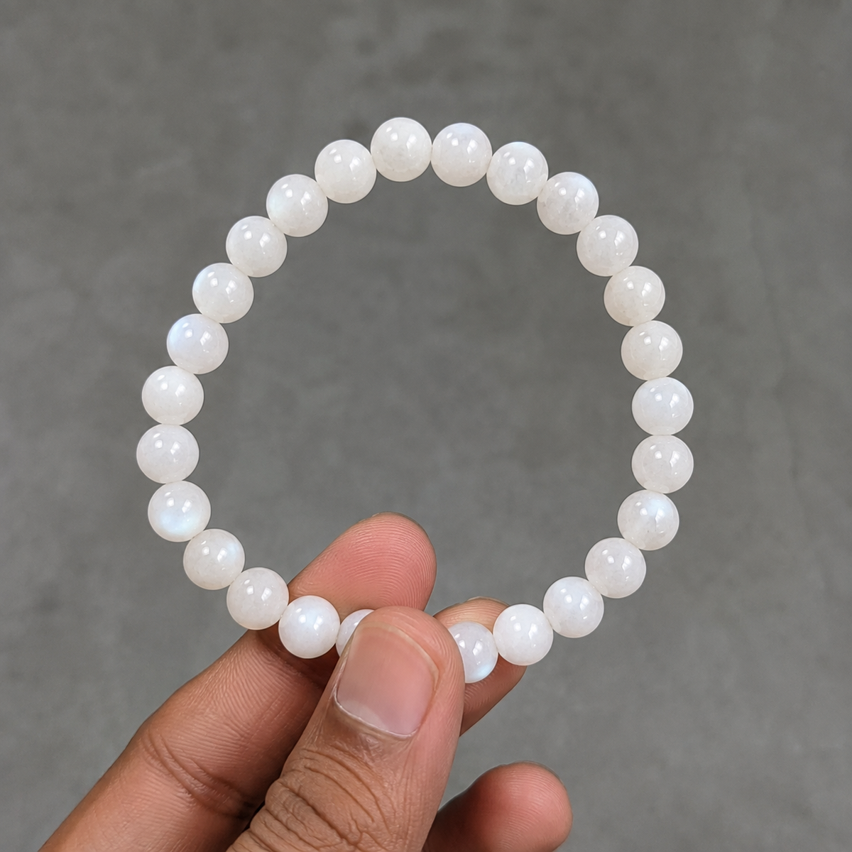 Close-up of AAA quality natural Moonstone bracelet held by hand