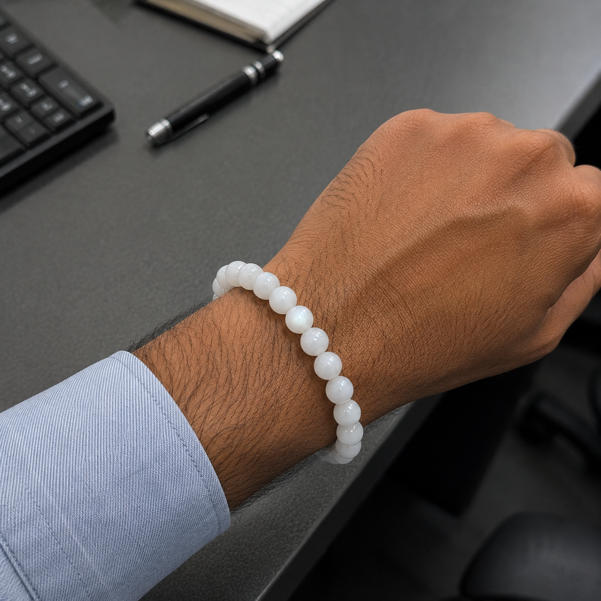Natural Moonstone bracelet worn on a man's wrist in an office setting