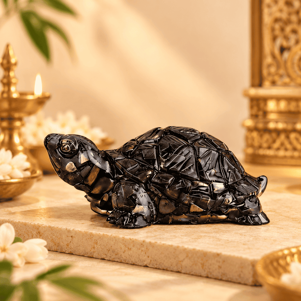 Black Pyrite Tortoise Vastu figurine displayed on a warm cream stone surface with elegant decor