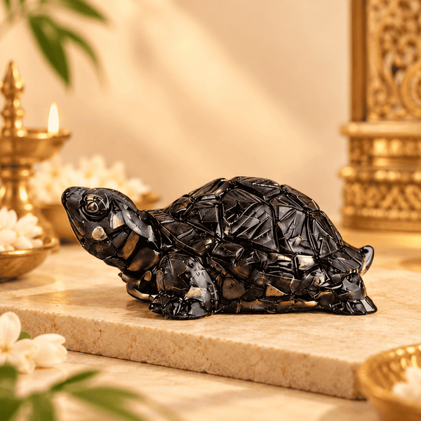 Black Pyrite Tortoise Vastu figurine displayed on a warm cream stone surface with elegant decor