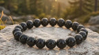 Close-up view of smooth polished Natural Black Obsidian Bracelet beads with a premium glossy finish